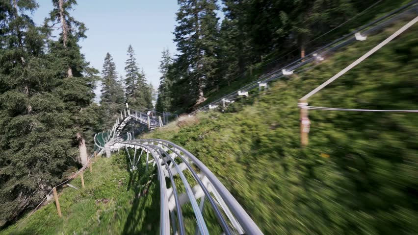 A thrilling roller coaster speeding through loops and sharp turns, showcasing excitement, adrenaline, and amusement park vibes.