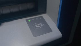 contactless payment pad on atm counter, green indicator light glows, closeup nfc symbol, customer taps card or smartphone, hand interaction focuses on finger press, modern banking convenience - Powered by Shutterstock - Get 15% off with code: PIKWIZARD15