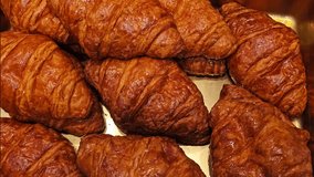 Fresh pastries and desserts at bakery display. Chocolate eclairs, cream tarts with macarons, and powdered sugar pastries arranged in boxes. Overhead view of sweet delicacies for sale. - Powered by Shutterstock - Get 15% off with code: PIKWIZARD15