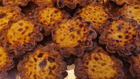 Fresh pastries and desserts at bakery display. Chocolate eclairs, cream tarts with macarons, and powdered sugar pastries arranged in boxes. Overhead view of sweet delicacies for sale. - Powered by Shutterstock - Get 15% off with code: PIKWIZARD15