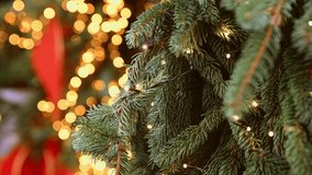 Evergreen pine branches decorated with delicate warm white fairy lights capture cozy holiday ambiance. Soft bokeh lighting complements red ribbon hues in softly focused background - Powered by Shutterstock - Get 15% off with code: PIKWIZARD15