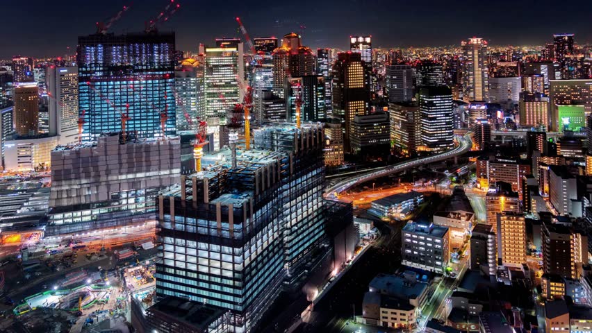 Time-lapse of Osaka city skyline, Japan, showcasing illuminated skyscrapers, bustling streets, and vibrant urban life from daylight to night.
