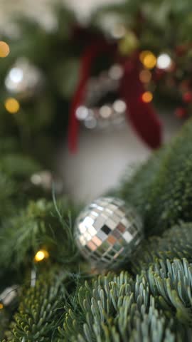 Sophisticated mirrored decoration nestled among evergreen branches