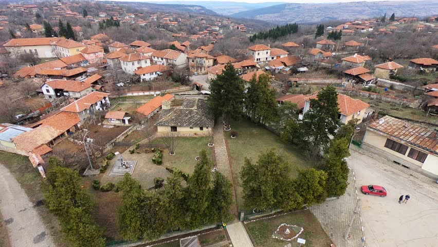 Low-altitude March drone footage of Kakrina Inn near Lovech, showing the historic building, courtyard and village in a smooth sideways move, BG, EU, 02 March 2019