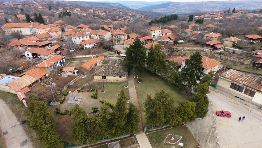 Low-altitude March drone footage of Kakrina Inn near Lovech, showing the historic building, courtyard and village in a smooth sideways move, BG, EU, 02 March 2019