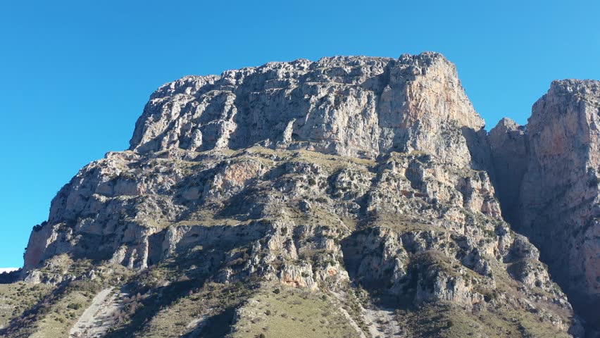 Aerial drone footage of impressive cliffs above Vikos Gorge in Zagori, Epirus, Greece. Dramatic rock formations and stunning natural scenery ideal for travel and nature projects.