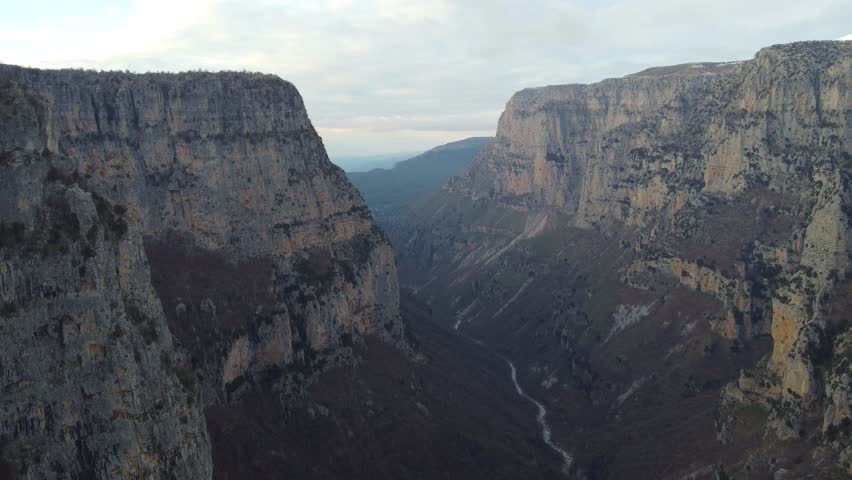 Aerial 4K drone footage of Vikos Gorge in Zagori, Epirus, Greece, showing a deep canyon, steep cliffs, and stunning natural scenery. Ideal for travel, nature, and documentary projects.