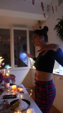 Woman in plaid dress dances while preparing snacks and desserts