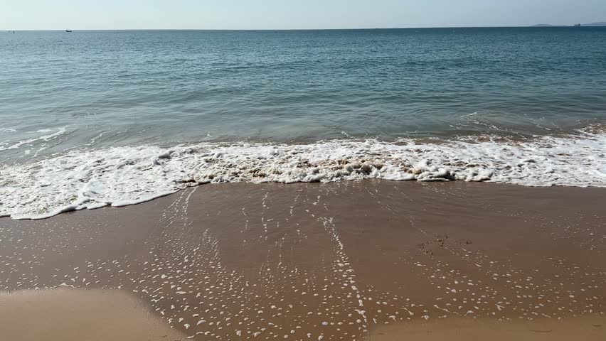 Waves rolling onto a sandy beach