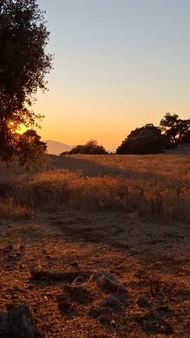 Sunset Over Mountain Landscape — Golden Light on Hills and Plains
