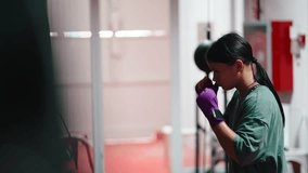 Young female boxer training punching bag at gym - Powered by Shutterstock - Get 15% off with code: PIKWIZARD15