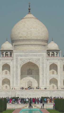 Agra, Uttar Pradesh, India. People visiting one of Seven world wonders - Fabulous Taj mahal. Famous indian islamic heritage at sunny day. Popular Place.