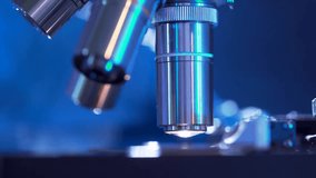Macro side view of a microscope turret being rotated, highlighting precise scientific equipment, laboratory work, and detailed focus adjustment in research. - Powered by Shutterstock - Get 15% off with code: PIKWIZARD15