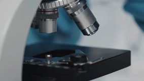 Scientist preparing a microscope slide in a chemical lab, highlighting laboratory work, research, and scientific analysis in 4K. - Powered by Shutterstock - Get 15% off with code: PIKWIZARD15