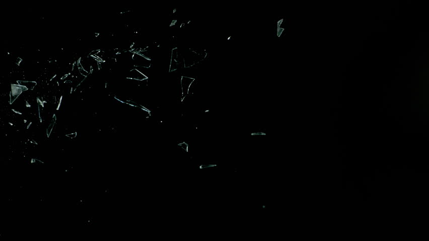 Super Slow Motion Shot of Real Side-Flying Glass Shards Isolated on Black at 1000 fps.