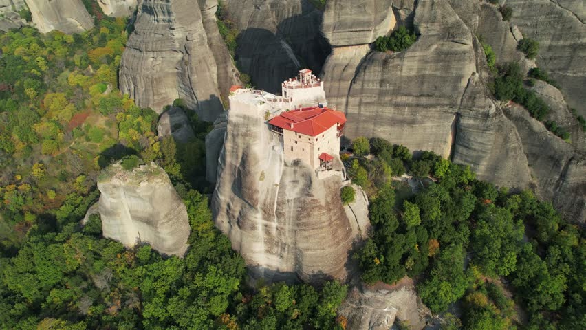 Meteora Cliffs and Monasteries, 4K Drone. Agios Nikolaos Anapafsas Monastery. Monastery on Giant Rock in Greece.