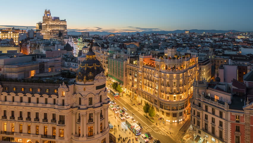 Dusk to night timelapse of historic buildings and traffic on Gran Via street in Madrid, Spain.