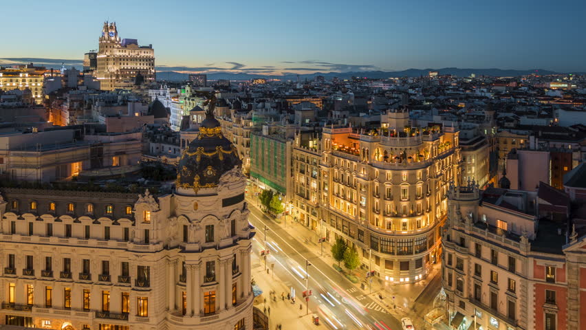 Dusk to night timelapse of historic buildings and traffic on Gran Via street in Madrid, Spain.