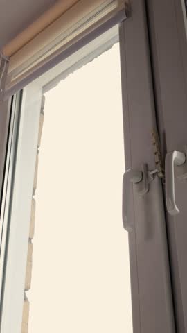 How to adjust window blinds with a simple movement in a bright room during daytime