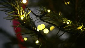 Close-up of a Christmas tree decorated with lanterns and red ribbons in an apartment, Christmas and New Year - Powered by Shutterstock - Get 15% off with code: PIKWIZARD15