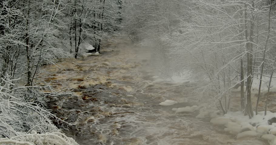 Rushing river of Nukarinkoski rapids, in snowy winter environment, Nukari, Nurmijärvi, Finland.