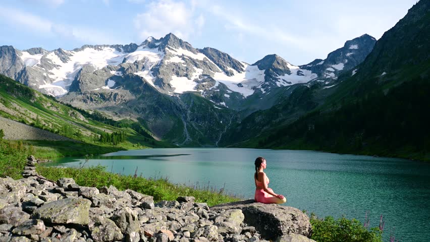 a woman on the shore of a mountain lake - Poperechnoye in Altai