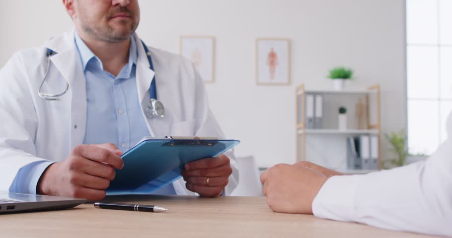 Mature male doctor close up consulting patient listening to complaints, GP giving consultation to client, discuss illness in hospital, healthcare worker explaining prescription, insurance protection