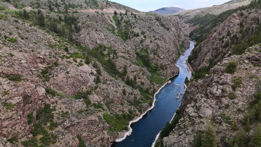 Drone flight through a granite canyon over the Gunnison River below in the high country of Colorado.  Upstream of Montrose and downstream of Blue Mesa Reservoir.