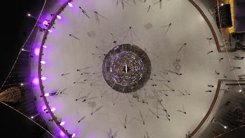 Drone Ascending Circling above Illuminated Ice Rink