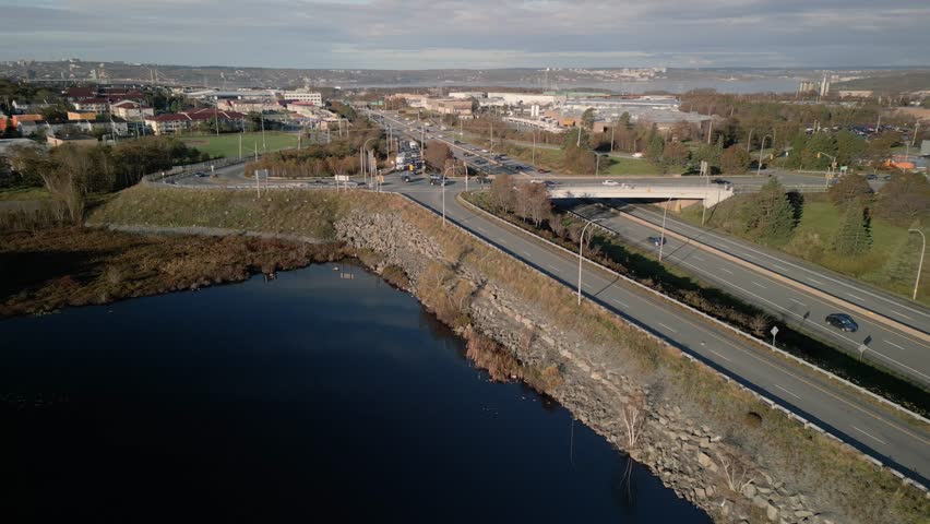 Aerial Scene Displays A Four Lane Highway In Dartmouth Nova Scotia Canada With Cars And Trucks Moving Steadily Across Wide Lanes Forming A Strong Urban Traffic And Transportation Atmosphere