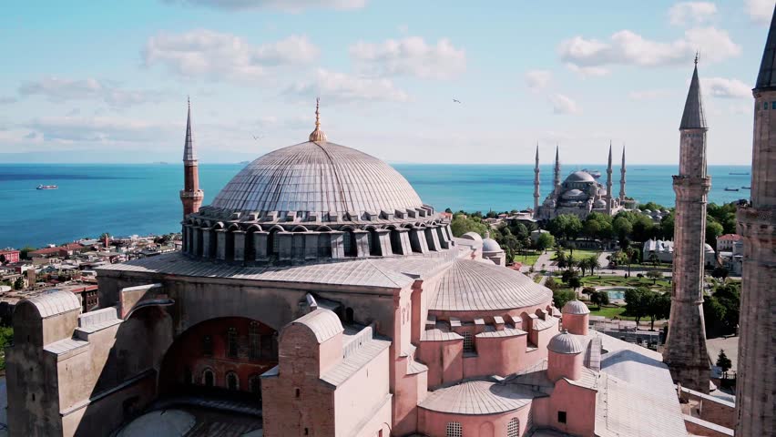 Aerial view of Istanbul and the Bosporus, showcasing the city skyline, blue strait waters, bridges, and vibrant urban landscape from above.