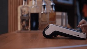 Person paying with a credit card using the contactless nfc system and fingerprint authentication - Powered by Shutterstock - Get 15% off with code: PIKWIZARD15