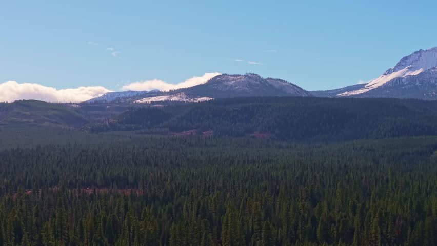 This scenic view captures the majestic, snow-covered mountains and volcanic peaks of Lassen Volcanic National Park