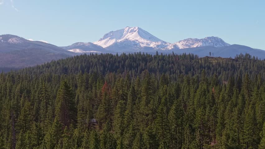 This scenic view captures the majestic, snow-covered mountains and volcanic peaks of Lassen Volcanic National Park