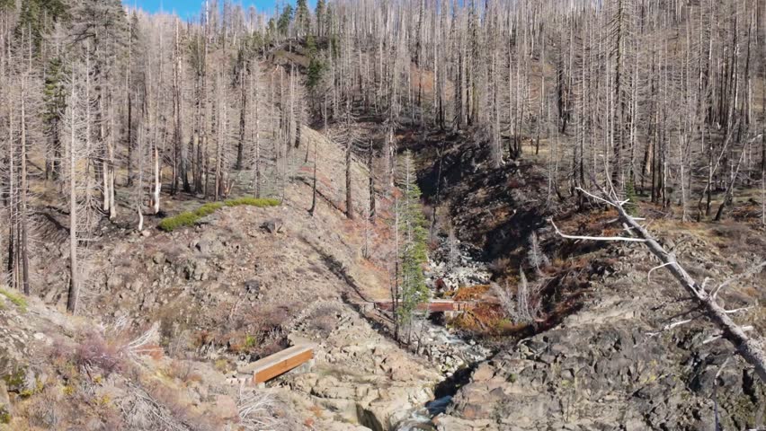 This scenic view captures Mill Creek Falls, the tallest waterfall in the park, cascading 75 feet down a narrow chute, visible from the end of a moderately strenuous trail