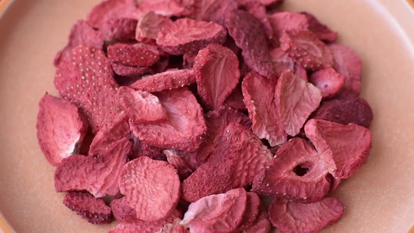 Dried sublimated slices of strawberry as an ingredient for sweet desserts. Dried strawberry as a food background for your design