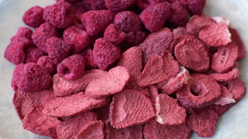 Dried sublimated slices of strawberry as an ingredient for sweet desserts. Dried strawberry and raspberry as a food background for your design