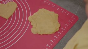 A young boy enjoys baking cookies with his mother. They roll out dough and cut it into various shapes while having fun in their cozy kitchen. - Powered by Shutterstock - Get 15% off with code: PIKWIZARD15