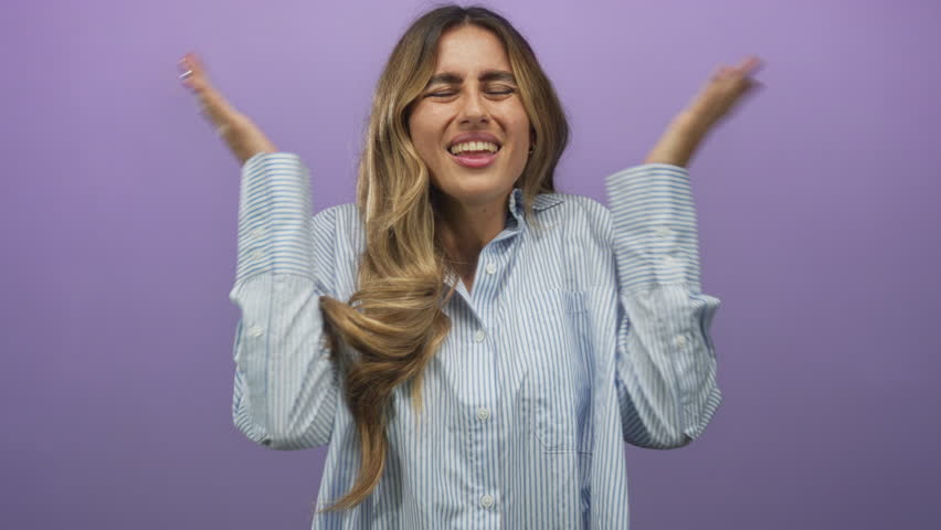 Young blonde woman lifts open palms and tilts head in purple studio; doubt curiosity bemusement hesitation.