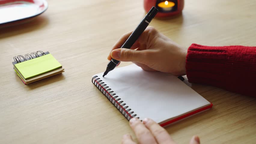 New year's resolutions. Hand writing 2026 text in notebook