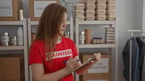 Volunteer checks clipboard while sorting donations in building; compassion community support service. - Powered by Shutterstock - Get 15% off with code: PIKWIZARD15