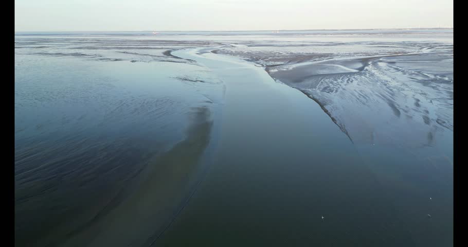 Aerial view of the tidal mudflats and channels of the Eemsdelta, Groningen, The Netherlands