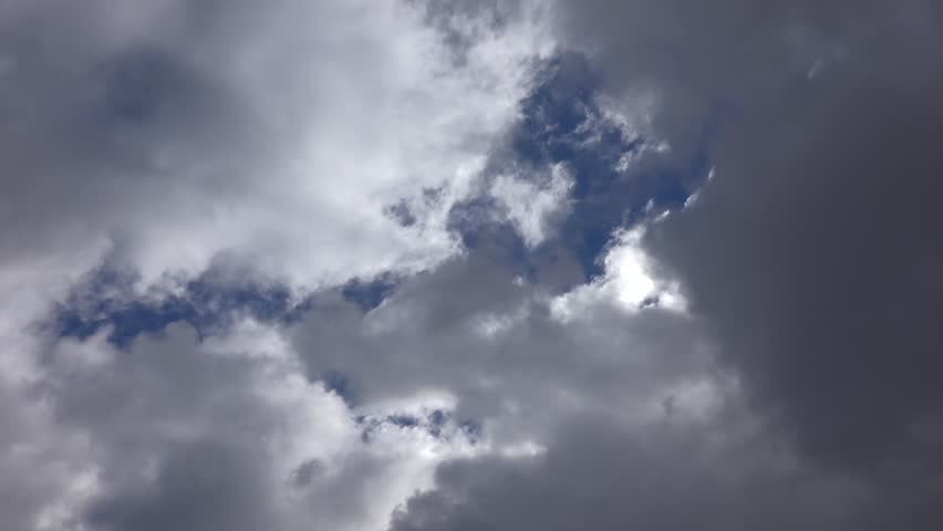 Time lapse cumulus clouds shifting across a partly cloudy sky after rain. Bright openings reveal moving formations as textured cloud layers reshape the clearing atmosphere.