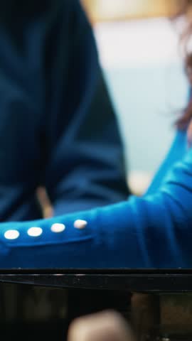 Vertical Video Retired couple preparing breakfast with toast from the toaster, standing together by the countertop. Man and woman enjoying a moment, chatting and bonding during retired life. Camera B.