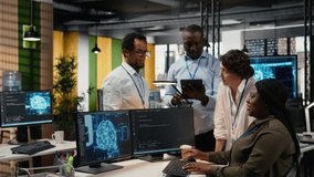 Multiethnic technicians use devices in AI startup office to train predictive models for language processing tasks. Multiracial coworkers use deep learning technical expertise for tasks, camera A - Powered by Shutterstock - Get 15% off with code: PIKWIZARD15