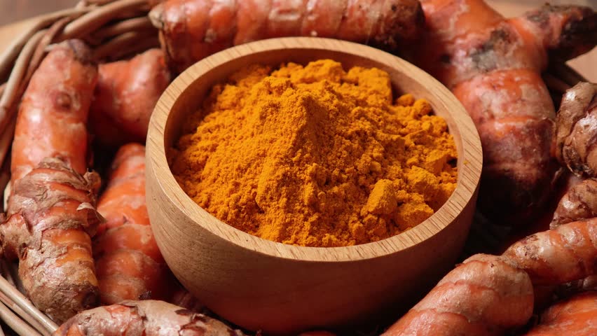 Turmeric powder in a wooden cup	
