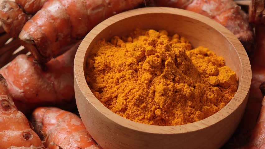 Turmeric powder in a wooden cup	