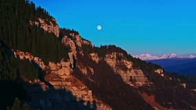Stunning aerial view of revealing Caucasus snowy mountains from the rugged rocks and dense forest, illuminated by a full moon perfectly centered in the sky. winter drone landscape captured from above. - Powered by Shutterstock - Get 15% off with code: PIKWIZARD15