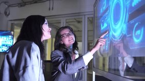 Two people are discussing cybersecurity in an office. They interact with a digital screen showing data and security graphics. The focus is on collaboration and technology use. - Powered by Shutterstock - Get 15% off with code: PIKWIZARD15