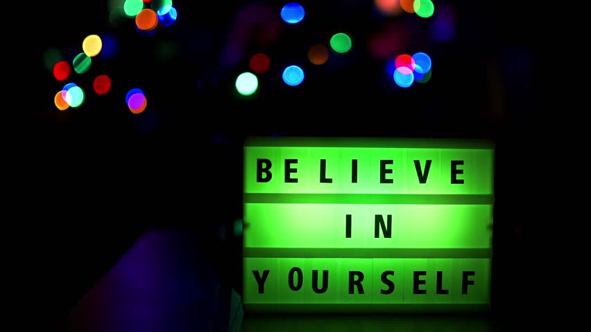 Believe in yourself quote written on a led light display with color changing. Static shot footage , nice soft background.